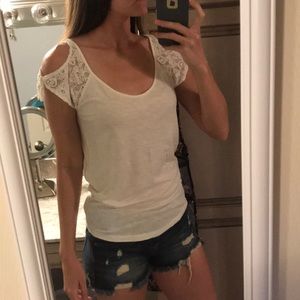 Lightweight off-white top with lace sleeves.